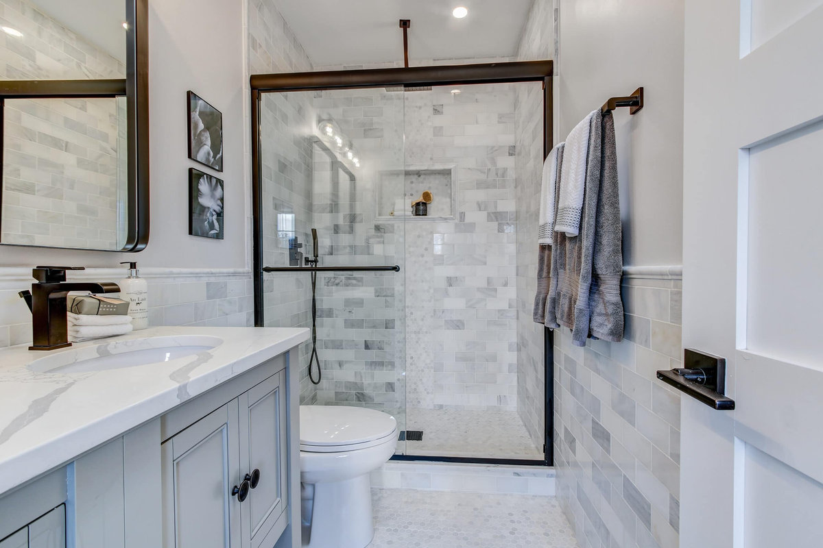 Completed bathroom makeover with a new vanity and tiled shower