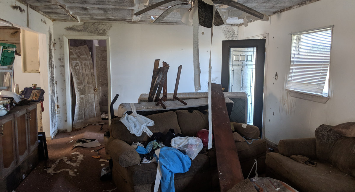 Storm-damaged living room before restoration